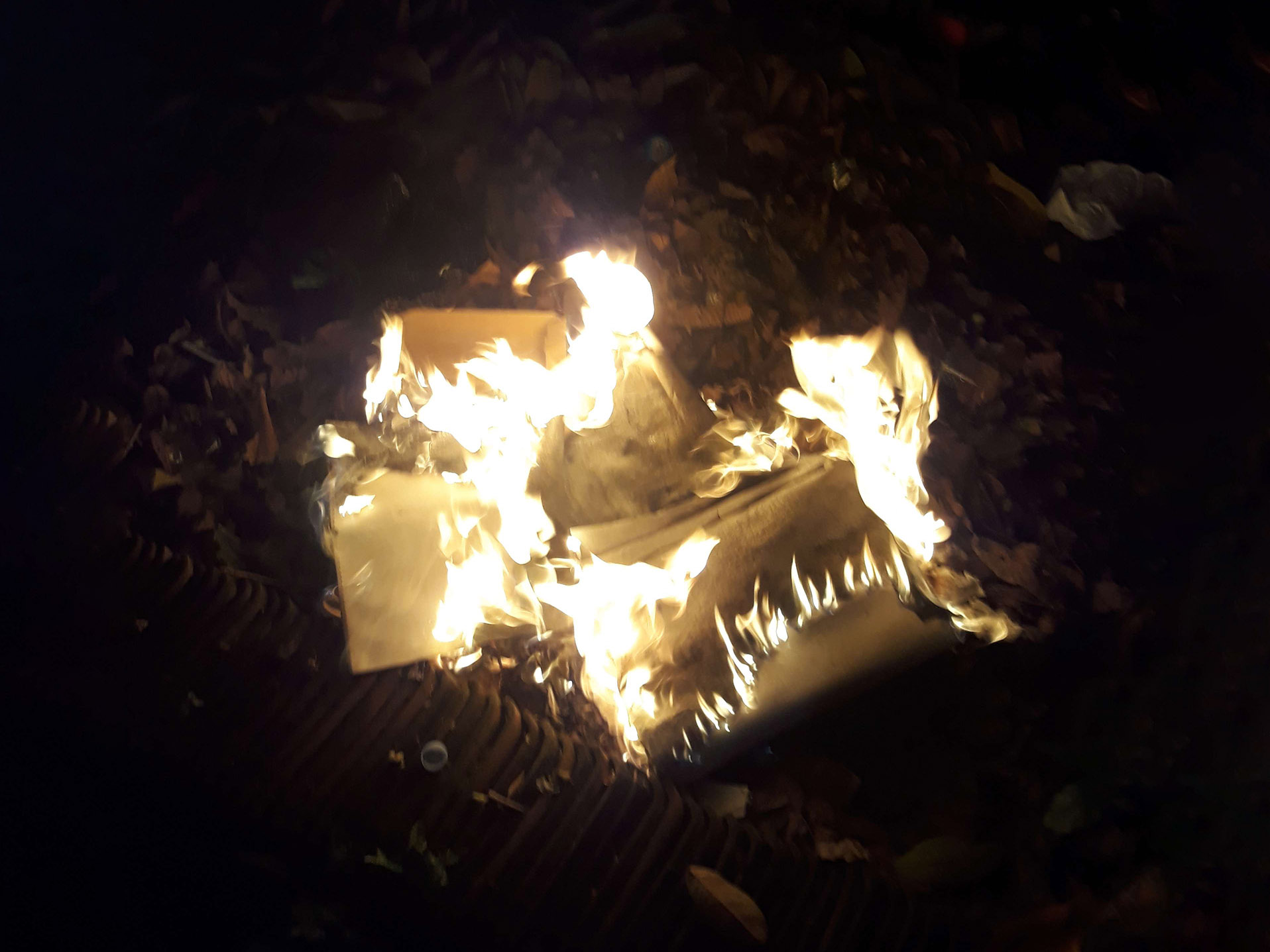 A photograph of letters got burned with fire, still lit.